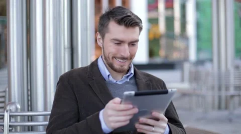 Man using tablet computer near the modern business center, Mall (slider shot) Stock-Footage 68401975