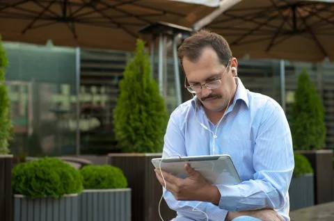 Man using tablet computer outdoors Stock Photos