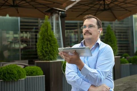 Man using tablet computer outdoors Stock Photos