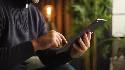 Man Using Tablet Computer Screen at Home Office Video stock 346810096