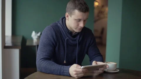 Man using tablet computer touchscreen in cafe 스톡 동영상 57227531