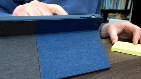 Man using tablet computer while making notes. Stock-Footage 88240359