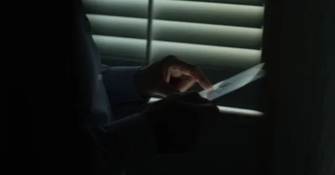 Man using a tablet in a dark mood 動画素材 76241236