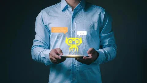 Man using tablet with digital robot icon and chat bubbles Stock Photos