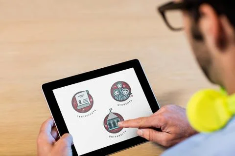 Man using a tablet with education icons on the screen Stock Photos