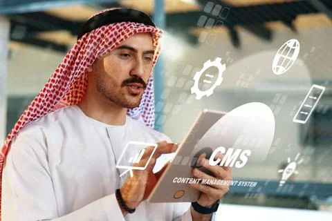 Man using a tablet to explore content management system features in office space Stock Photos