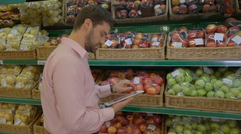 Man using tablet at fruit counter In supermarket Stock Footage 63367011