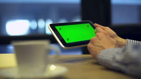 Man using Tablet with Green Screen in coffee house Stock Footage 81482695