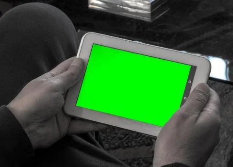 Man using a tablet with green screen Stock-Fotos