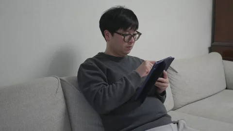 Man using tablet at home Stock Footage 259961137