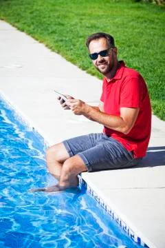 Man using tablet, looking at camera. Stock Photos