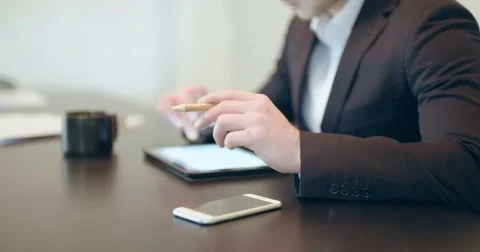 Man using tablet in Office (finance background) Stock Footage 83188941
