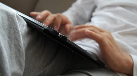 Man using tablet pc and typing on tablet screen with fingers Stock Footage 37244207
