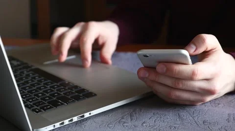 Man is using tablet pc and mobile phone. He is sitting behind the table Stock Footage 61281030
