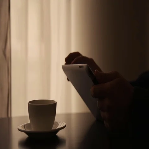 Man Using Tablet PC and Drinking Coffee in Cafe Stock Footage 69577014