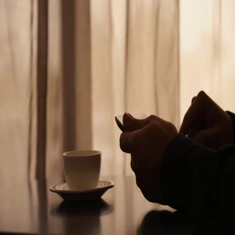 Man Using Tablet PC and Drinking Coffee in Cafe Stock Footage 69577313