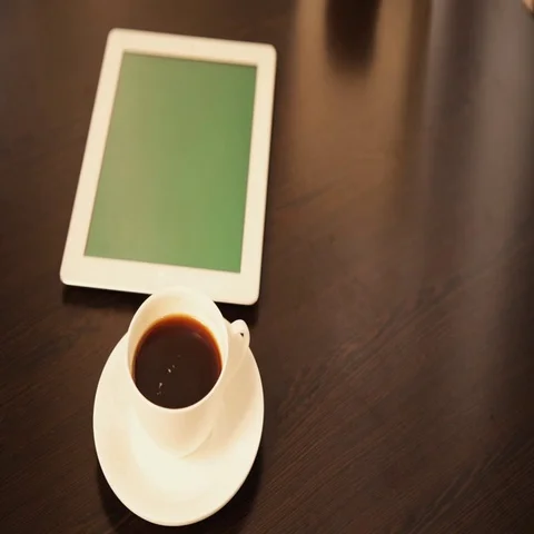 Man Using Tablet PC and Drinking Coffee in Cafe Stockbeeldmateriaal 69578359