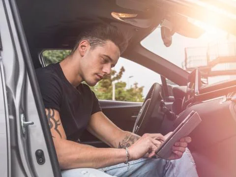 Man using tablet PC in car Stock Photos