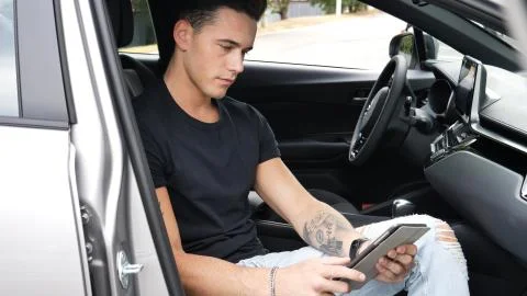 Man using tablet PC in car Stock Photos