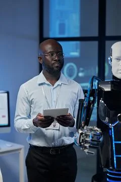 Man using tablet pc to control the robot 写真素材