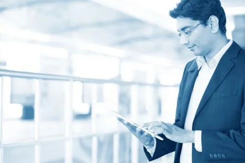 Man using tablet pc at railway station Stock Photos