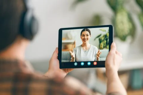 Man is using tablet pc for remote conversation Stock Photos