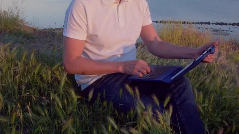 Man using tablet pc on the rock outdoor Stock Footage