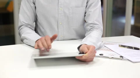 Man using a tablet pc in start up office, looking camera Stock Footage 43739479
