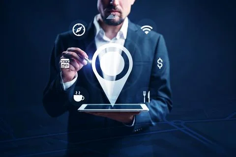 Man using tablet to plan taxi route with travel apps and navigation tools at Stock Photos