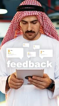 Man using a tablet to read feedback in a modern workspace in the Middle East Stock Photos