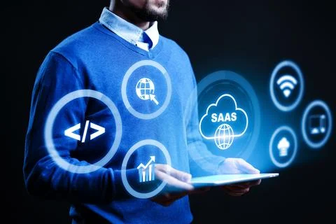 Man using tablet with SaaS symbols representing software as a service concepts Fotos Stock