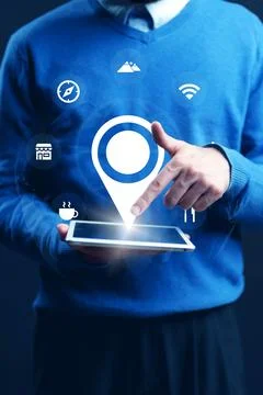 Man using tablet to select taxi route on map for travel navigation in city Stock Photos