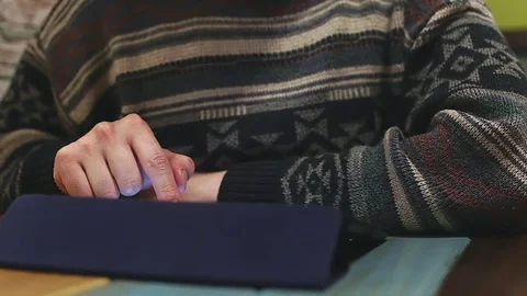 Man using tablet for shopping. Browsing computer touchscreen on wooden table Video stock 76562848