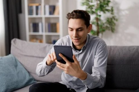 Man using tablet on sofa Foto stock