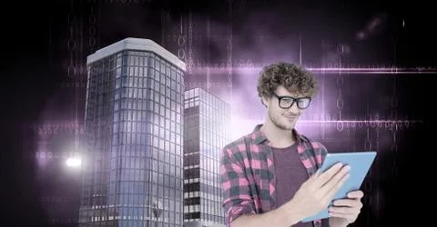 Man using tablet with Tall buildings with dark binary code flares 스톡 사진