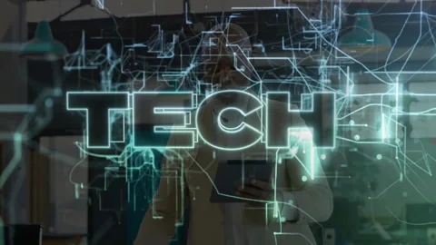Man using tablet in tech lab, interacting with holographic circuit overlay and Stock Footage 307453339