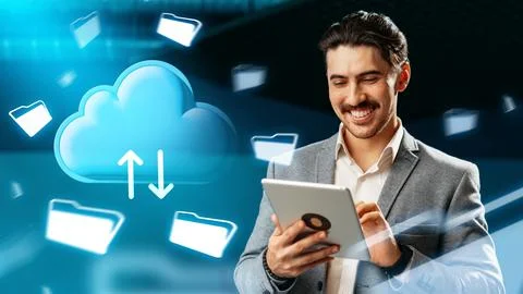 Man using tablet to upload files to cloud storage service in a data center Stock Photos