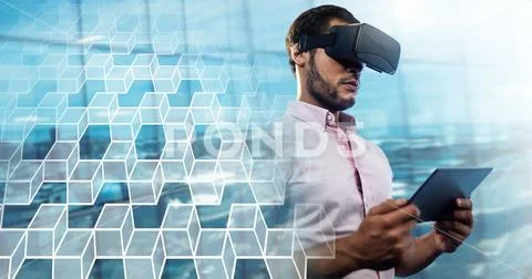 Man using tablet with virtual reality headset with geometric transition Stock Photos