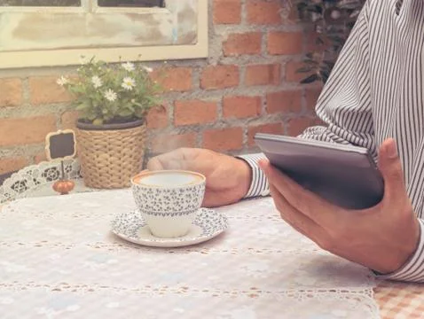Man using tablet while drinking coffee Foto stock