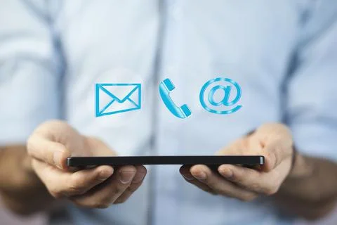 Man using tablet  while emitting a clouds of contact icons in a conceptual im Stock Photos
