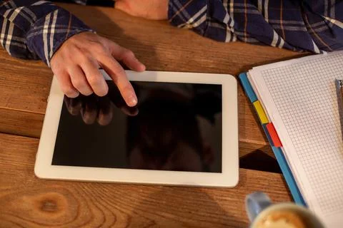 Man using tablet works. White tablet with blank screen in a man hands Stock Photos