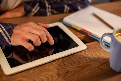Man using tablet works. White tablet with blank screen in a man hands Stock Photos