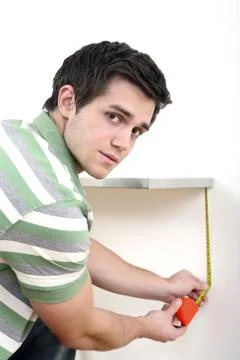 Man using tape measure Stock Photos