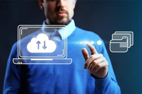 Man using technology to manage cloud services and data transfer on a laptop.. Foto stock