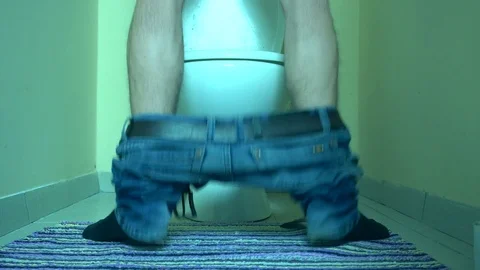 Man using toilet, putting on his jeans Stock Footage 72111440