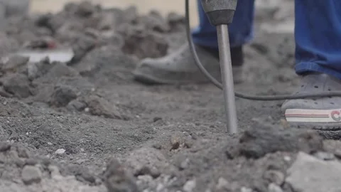 Man using tool on ground at construction site during work Stock Footage 346580007