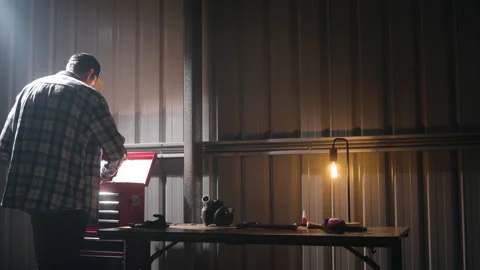 Man using Toolbox on the workbench in a Industrial Garage Stock Footage 164358809