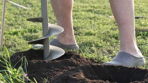 Man using tools hand-held portable manual earth auger for prepare the soil for Stock Footage 204819660