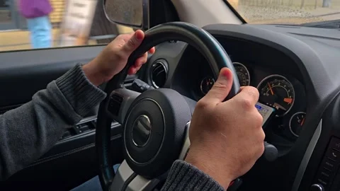 Man using touch mobile phone in car, to study Google maps for driving on roads Stock Footage 305997661