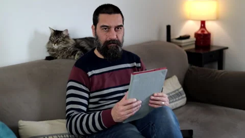 Man using touchpad sitting on sofa at home. Stock Footage 266301930